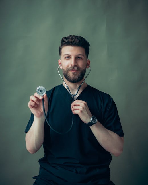 Portrait of a young male doctor with a stethoscope, wearing a black t-shirt.