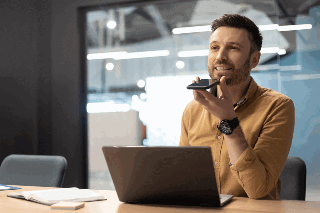 Voice recognition technology on a man's smartphone in a modern office setting, digital communication, business productivity, innovative tech, The Solemn Sir branding.